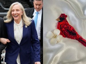 On left, virginia governor abigail spanberger in a blue suit and white shirt. on right, close up of beaded cardinal and dogwood flower pins.